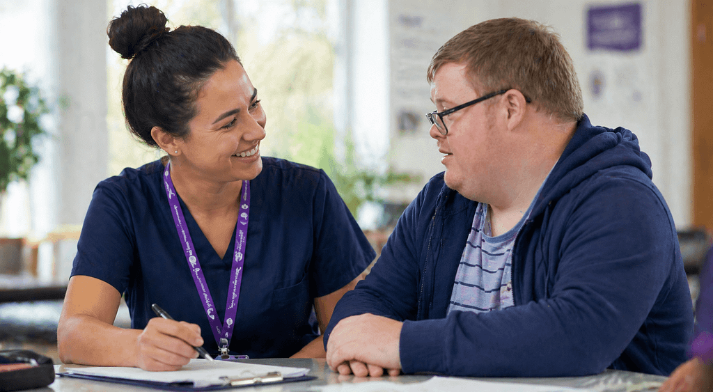 Healthcare professional supporting a man with learning disabilities